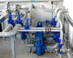 Water pumping station, industrial interior and pipes. Water system valves, electronic motor control water supply